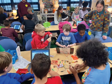 elementary students on laptops